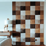 A living room with the 3D wooden square wall panels installed in several different wood finishes.
