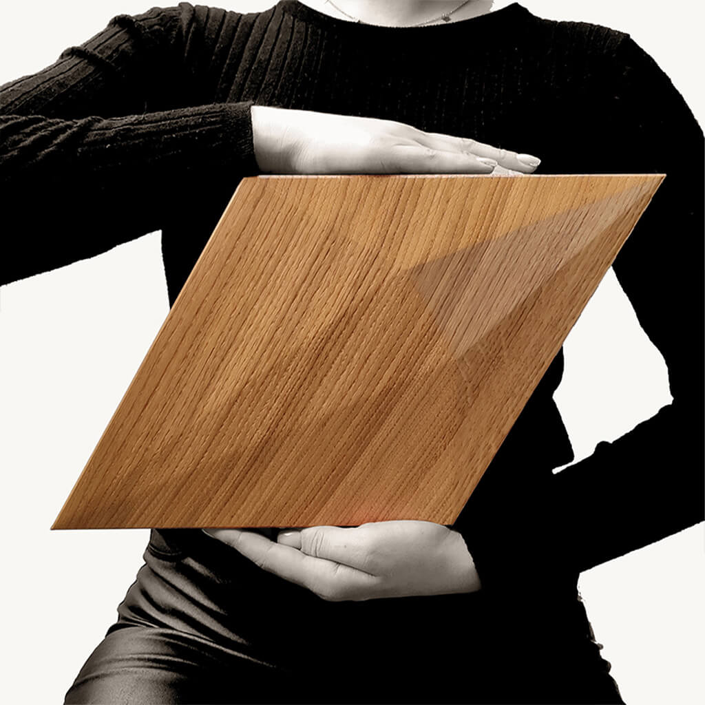 To show the scale a person holding one of the diamond shaped wooden panels at chest height.