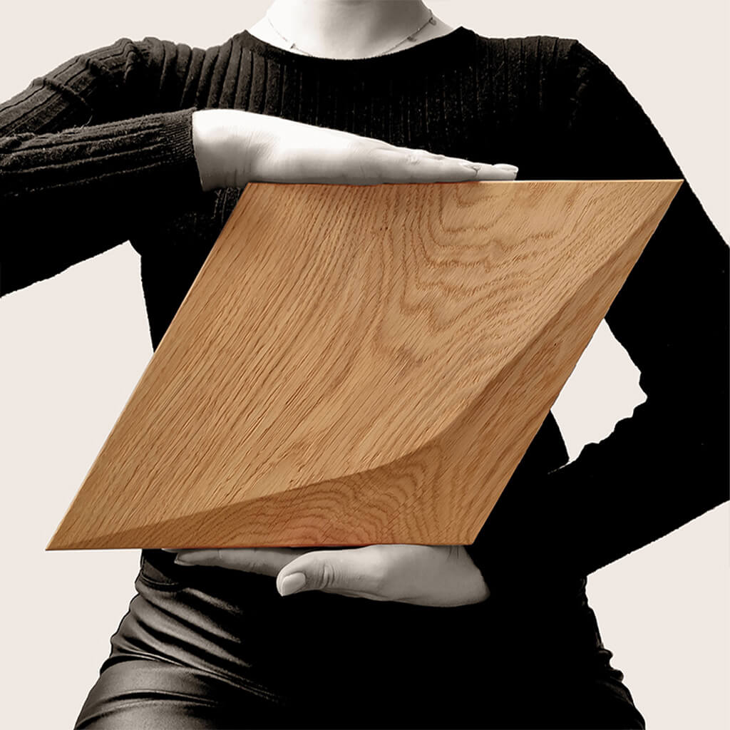 To show the scale a person holding one of the Caro diamond shaped wooden panels at chest height. 