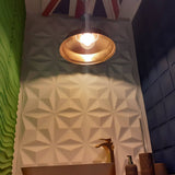 Decorative 3D wall panels painted green and blue within our showroom in Bolton