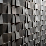A shot of a wall from an angle which is decorated in the grey Latgale panels. The image shows that shadows created by the 3D squares in the design.