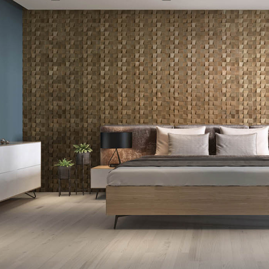 A 3D square wall panel design is an light oak colour. This wall is behind a bed in a contemporary bedroom.
