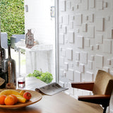 3D wall panel used as a backdrop at a dining table.