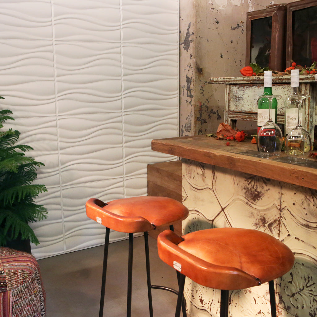A rustic breakfast bar with 3D wall panels in the background.