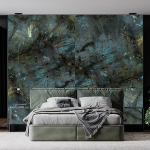 The image is looking at a double bed in greens and greys. Behind the bed is the Stardust wall panels in similar green colours.