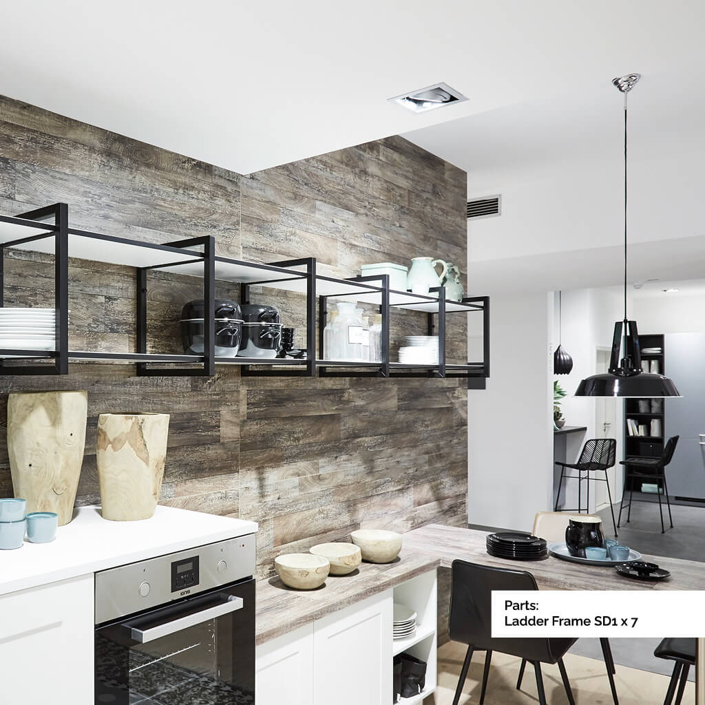 Long length of black and white shelving on a grey kitchen wall