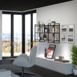 Wall mounted black metal framed shelving containing books and ornaments in a lounge area with patio doors