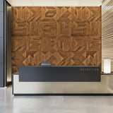 A stylish reception desk in black and brushed gold. Behind the desk is the walnut Mod wall panels.
