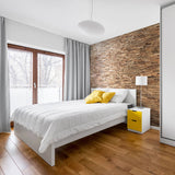 A minimalistic crisp fresh hotel bedroom where the main feature is the 3D wooden panels behind the bed.