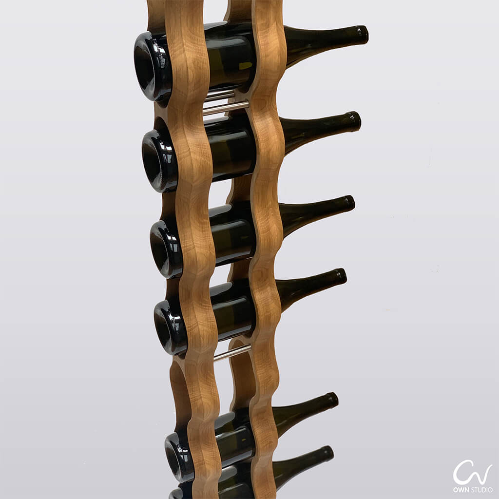 Close up of the curvy tall Omo wine rack holding 6 bottles of red wine.