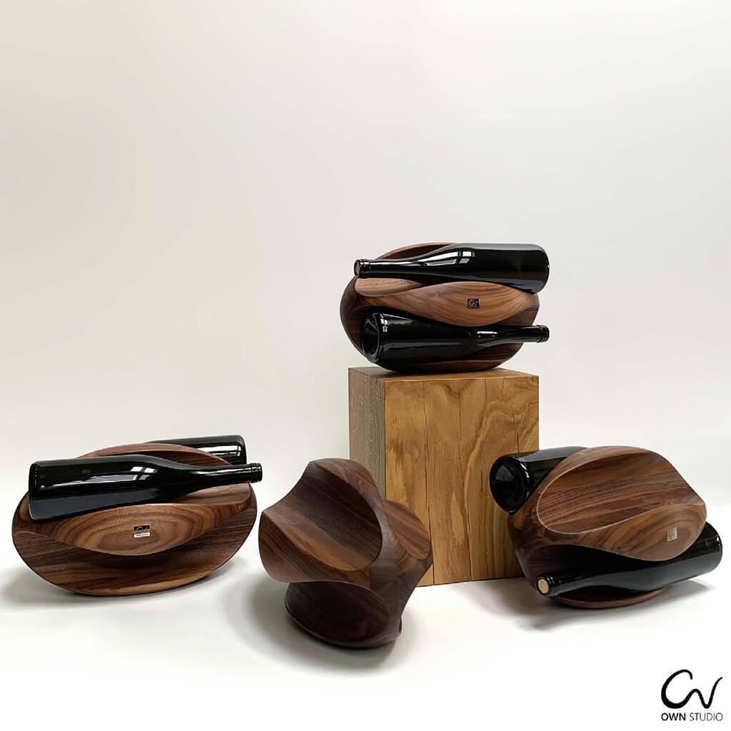 Selection of 4 stylish Rugby wine racks each in walnut wood. Several of the rounded wine racks are holding red wine