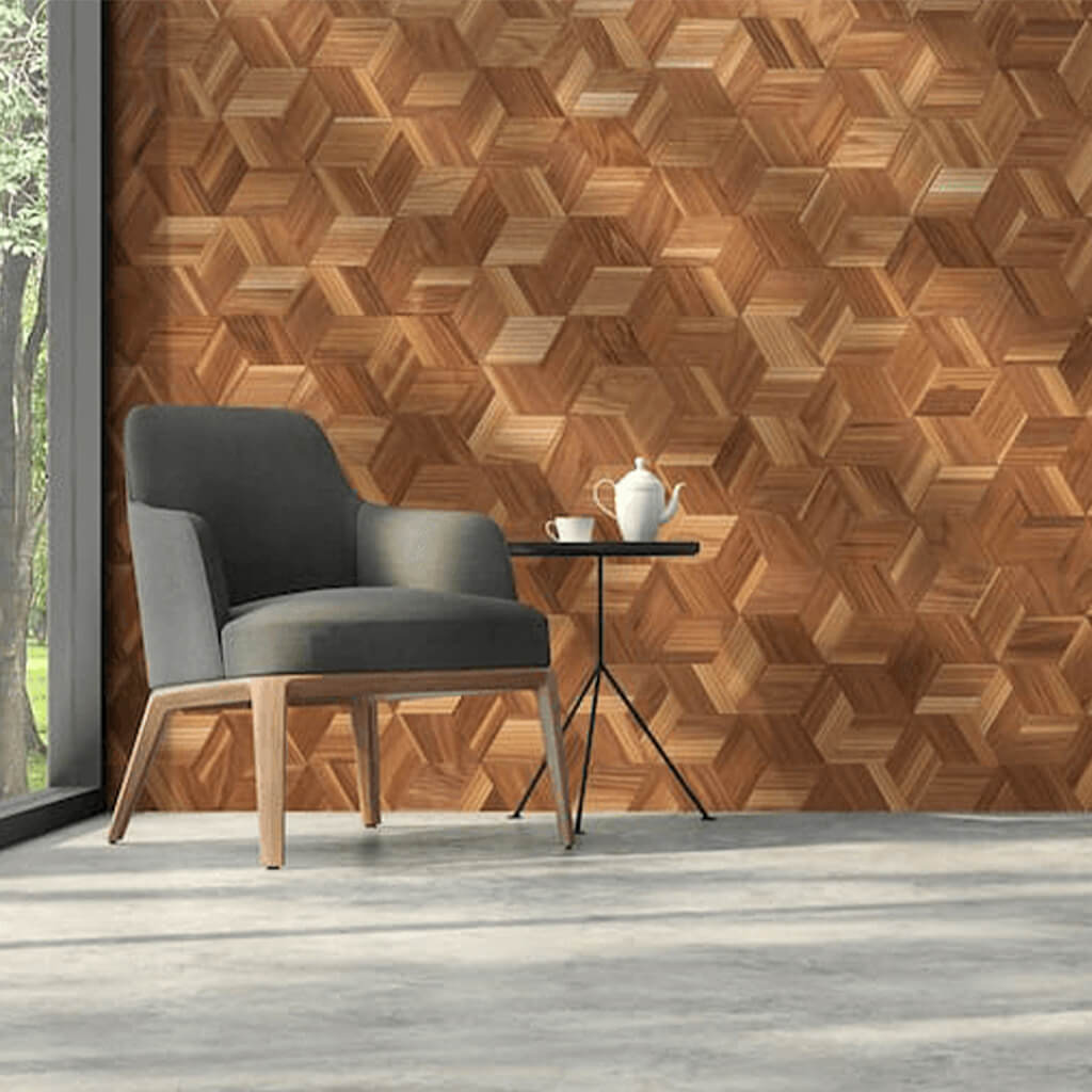 An interior where there is a arm chair to the left of the image. The main focus is the walnut wall panels installed behind the chair. These wall panels vary in walnut colours and are in patterns of hexagon shapes.