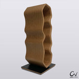 An oak wood tabletop wine rack. The wine rack is in a wavy design and can hold 4 bottles.