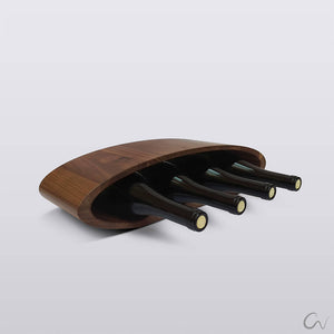 A tabletop walnut wine rack in which 4 bottles of wine can fit in a row.
