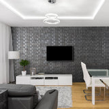 A grey living room where the back wall includes the Latgale wall panels. These panels are a grey wood in a 3D square design.